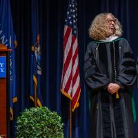 faculty laughing on stage